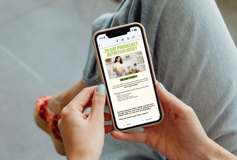 Woman reading daily action email on phone